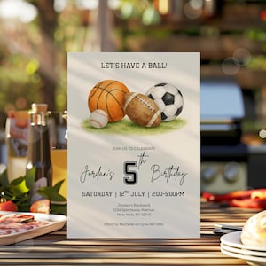 May include: A birthday invitation with the text "LET'S HAVE A BALL!" and "Jordan's 5th Birthday." The invitation features illustrations of a basketball, football, soccer ball, and baseball on a green field.