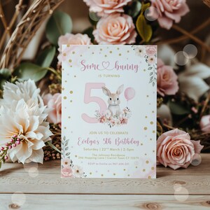 May include: A birthday invitation with the text "Some bunny is turning 5". The invitation features a bunny illustration with a pink balloon and floral accents. The invitation is for Evelyn's 5th birthday.