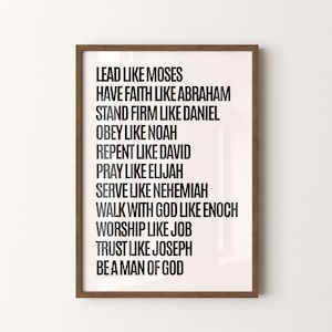 Puede incluir: Impresión enmarcada con fondo blanco y texto negro. El texto incluye frases como "Lidera como Moisés" y "Sé un hombre de Dios". El marco es de color marrón oscuro.