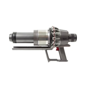 May include: A cordless, handheld vacuum cleaner in shades of gray. The vacuum features a cylindrical body, a handle, and a trigger. The brand name "Dyson" is visible on the side. The design includes red accents and a mesh vent.