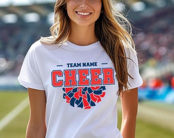 May include: White t-shirt with a blue and red cheerleading pom-pom graphic and the text "TEAM NAME CHEER" printed on the front.