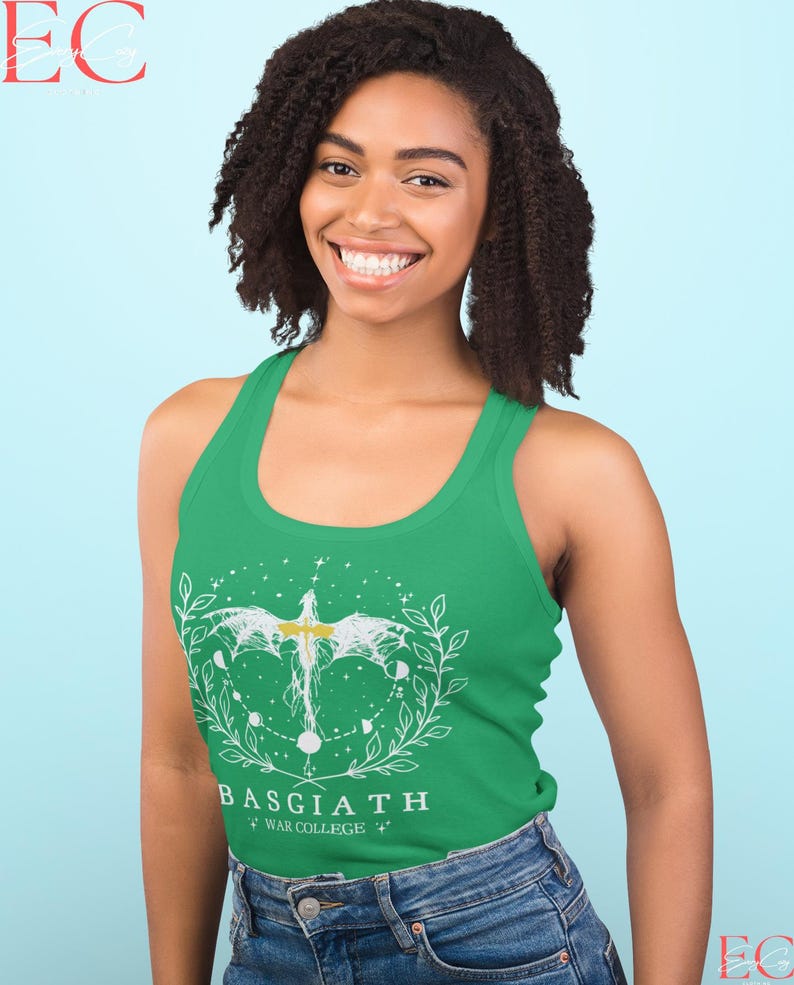 May include: A green vest top with a white graphic design featuring a stylized bird, celestial elements, and the text "BASGIATH WAR COLLEGE". The design is framed by a leafy wreath. The vest top is worn with blue jeans.