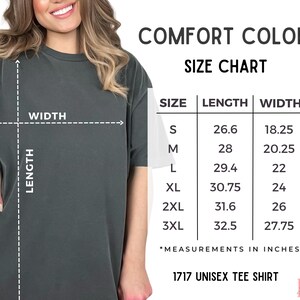 May include: A dark gray unisex tee shirt with a size chart. The chart shows measurements in inches for sizes S to 3XL. The shirt is labeled as a "1717 Unisex Tee Shirt" and is part of the "Comfort Colors" collection.