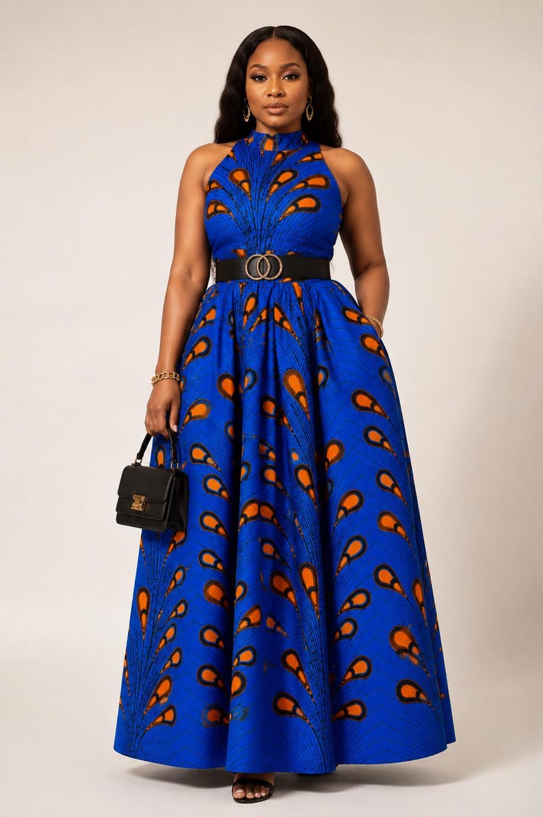 May include: A floor-length sleeveless dress in a vibrant blue fabric featuring a repeating orange and black feather-like pattern. The dress has a high neckline, a fitted bodice, and a full, pleated skirt cinched with a wide black belt.