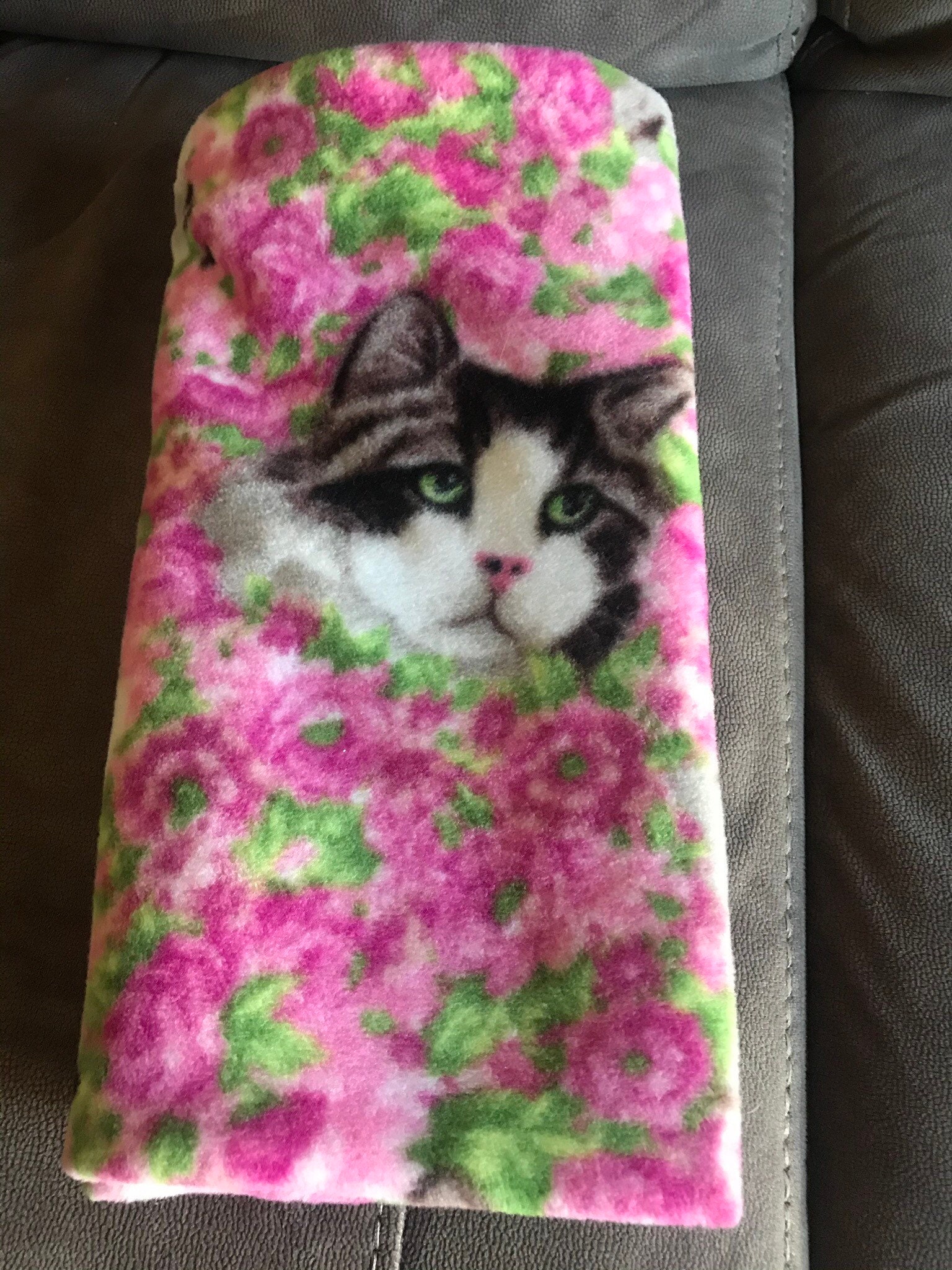 Fleece cat blanket pink flowers in the background with three Etsy