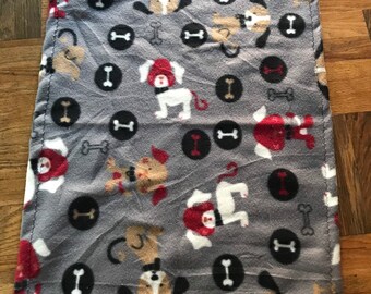 Two Fleece dog blankets, this listing is for two small fleece dog blankets grey background red, white and tan dogs, with dog bones 23x27