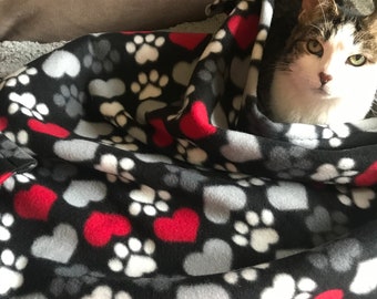 Fleece cat or dog blanket (small), with a black background and with red and grey hearts, and white and grey paws