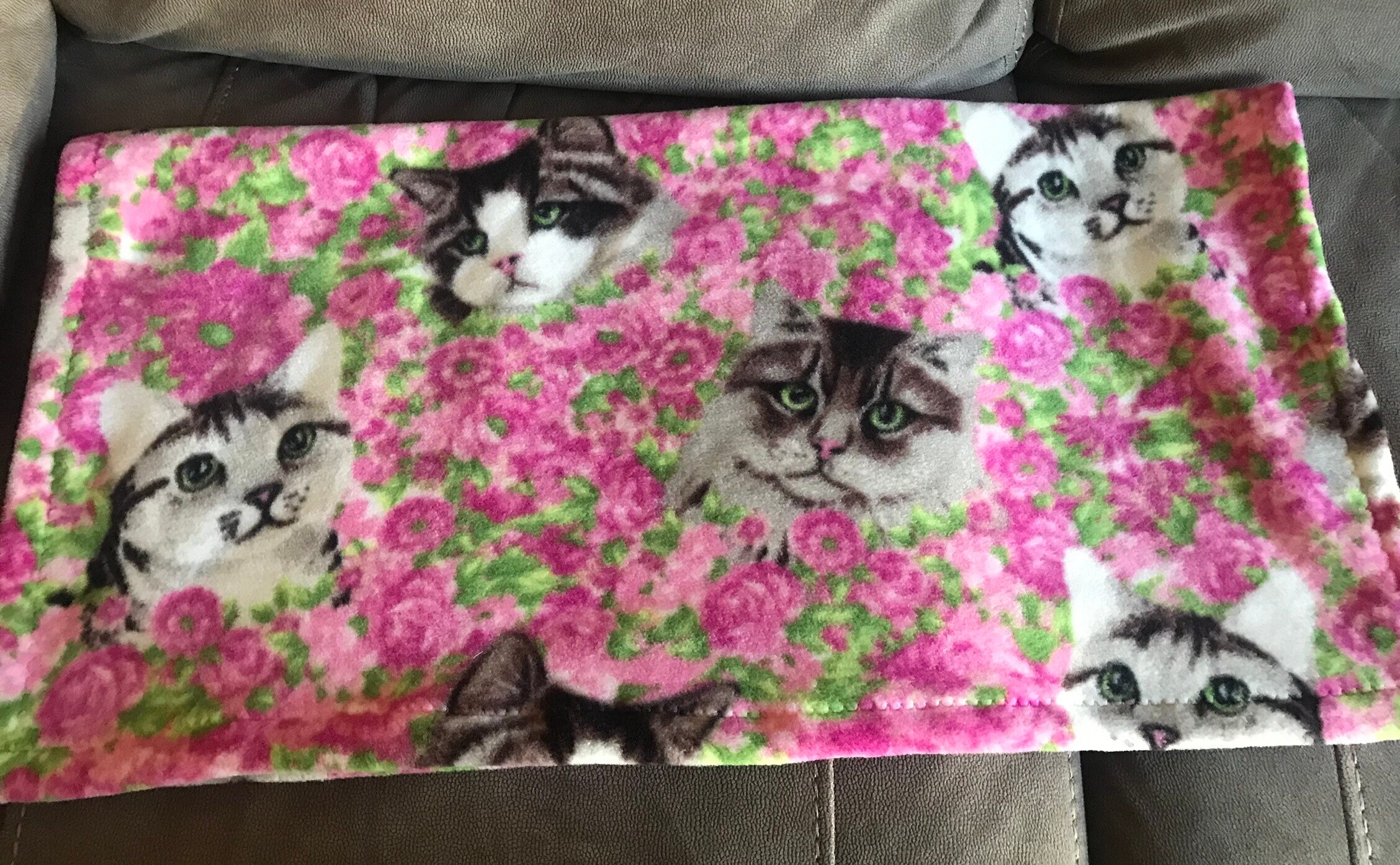 Fleece cat blanket pink flowers in the background with three Etsy