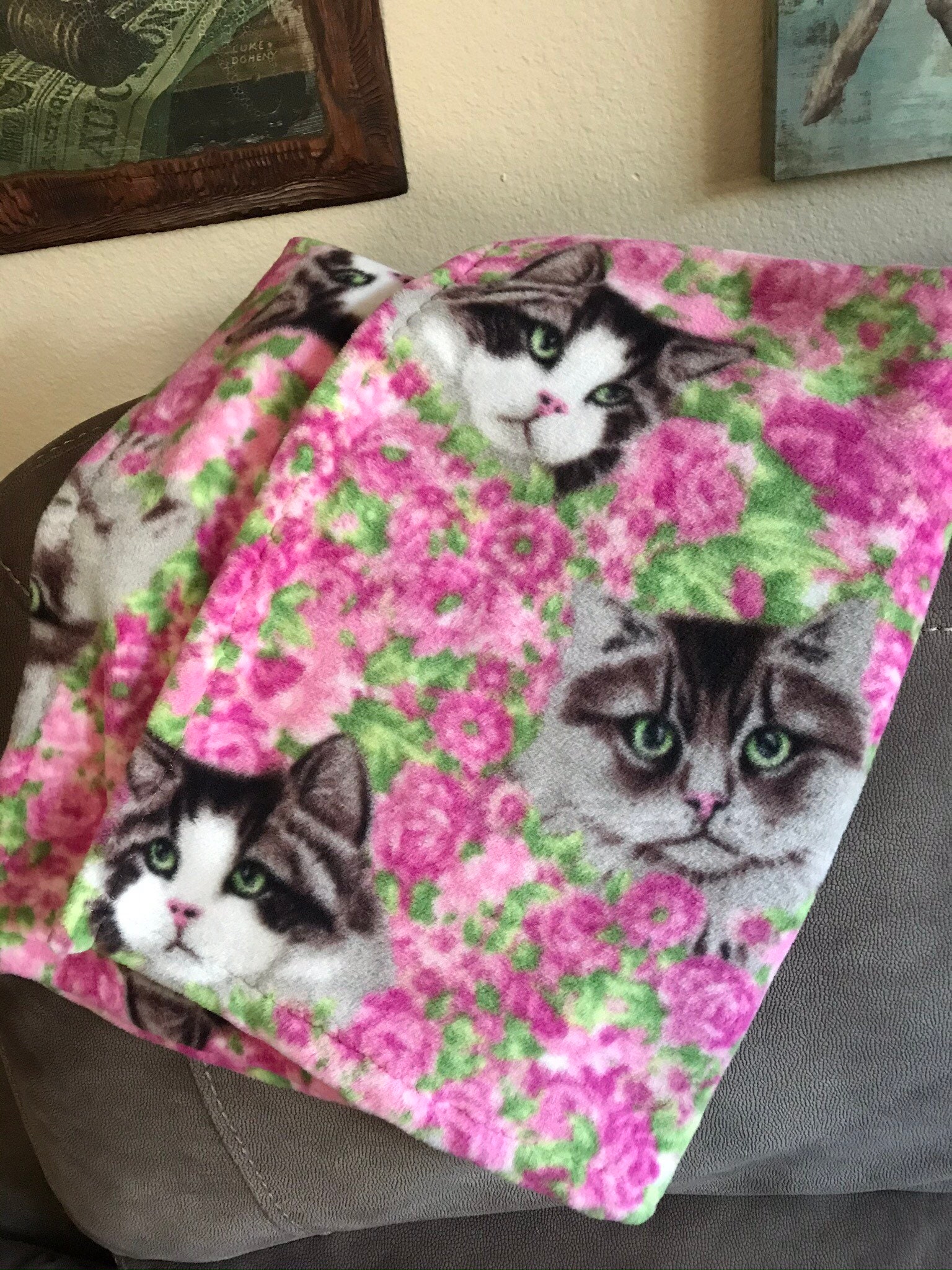 Fleece cat blanket pink flowers in the background with three Etsy