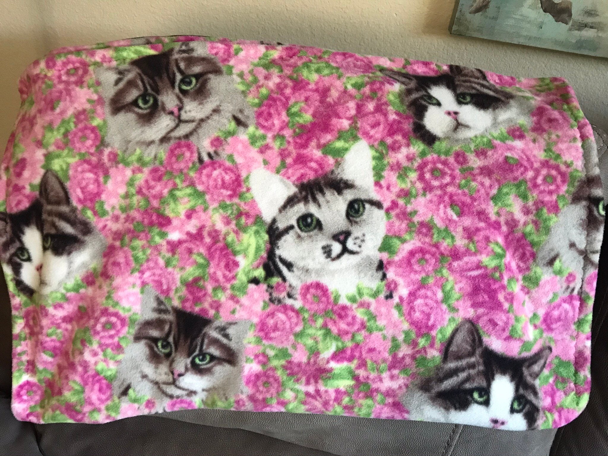 Fleece cat blanket pink flowers in the background with three Etsy
