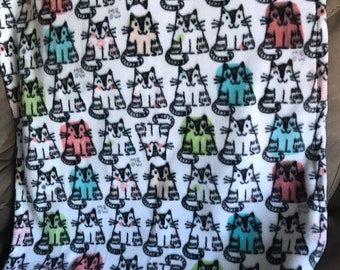fleece cat blanket, plush fleece with  cats, a few are green, teal,orange and pink, the word MEOW is written in grey (small/medium)