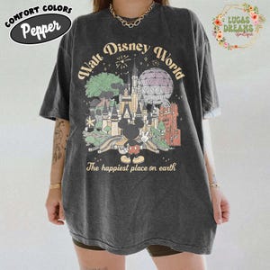 May include: Dark gray t-shirt with a vintage-style Walt Disney World graphic. The design features a castle, Spaceship Earth, and Mickey Mouse. Text includes "Walt Disney World" and "The happiest place on earth."