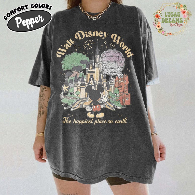 May include: Dark gray t-shirt with a vintage-style Walt Disney World graphic. The design features a castle, Spaceship Earth, and Mickey Mouse. Text includes "Walt Disney World" and "The happiest place on earth."