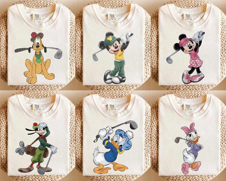 May include: Six off-white t-shirts featuring Disney characters playing golf. Pluto, Mickey Mouse, Minnie Mouse, Goofy, Donald Duck, and Daisy Duck are depicted in colorful cartoon graphics, each holding a golf club.