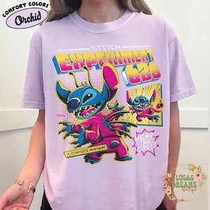 May include: Orchid Comfort Colors t-shirt featuring a graphic of Stitch from Disney's Lilo & Stitch. The design includes the text "Experiment 626" and "A Complete Mayhem!" in vibrant colors. The shirt is a light purple color.