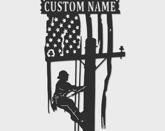 May include: A black metal wall sign featuring a silhouette of a utility worker climbing a wooden pole. The design incorporates a stylized American flag with stars and stripes, and a top banner with the text CUSTOM NAME cut out in metal.