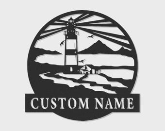 May include: A circular black metal wall art piece featuring a lighthouse silhouette with radiating light beams, flying birds, and a coastal landscape. Below the circular design is a rectangular banner with the text CUSTOM NAME in white.
