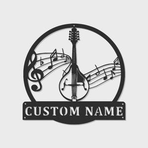 May include: Black metal wall art featuring a mandolin, musical notes, and a treble clef within a circular frame. The words "CUSTOM NAME" are displayed on a rectangular banner below the circle. A decorative piece for music lovers.