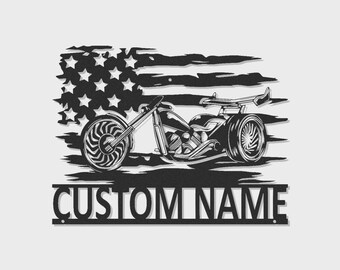 May include: A black metal wall art piece featuring a stylized motorcycle silhouette layered over a distressed American flag design. Below the motorcycle, a rectangular banner contains the bold, capitalized text CUSTOM NAME.