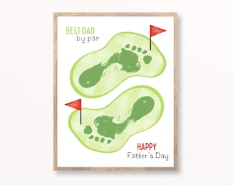 May include: A framed print with a Father's Day theme. The artwork features two green golf course footprints with red flags, and the text "BEST DAD by par" and "HAPPY Father's Day" in green and red.