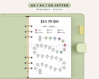 May include: A light green ring binder containing a Rate My Day printable page with a dotted grid, a star-shaped habit tracker numbered 1 through 31, and a color-coded mood legend. The top text reads A5 | A4 | US LETTER and PRINTABLE + DIGITAL.