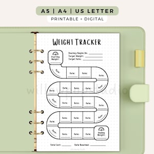 May include: A weight tracker printable page inside a light green binder. The page features a black and white winding path design with fields for Starting Weight, Target Weight, Target Date, Total Lost, and Date Reached, plus date entry boxes.