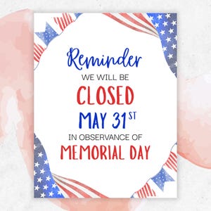 May include: A white sign with the text "Reminder" and "We will be closed May 31st in observance of Memorial Day." The sign is decorated with watercolor American flags and stars.