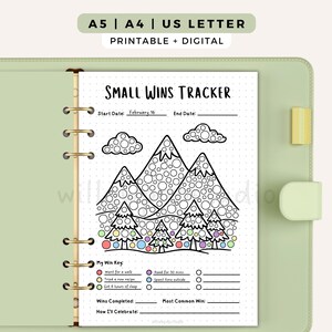 May include: A printable Small Wins Tracker page in a light green binder. The page features a mountain and tree graphic with circles to colour, a My Win Key section with coloured dots, and lines for tracking wins, dates, and celebration plans.
