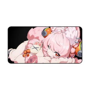 May include: A rectangular mousepad featuring a pink anime-style character with orange eyes and headphones. The character is lying down, with a plush bunny and orange fruit accents. The background is black.