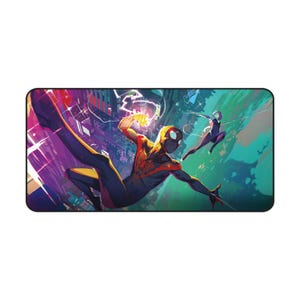 May include: Rectangular mousepad featuring a dynamic illustration of Spider-Man in a superhero pose, with a cityscape backdrop. The design showcases vibrant colors, including red, black, and blue, with a second character in the background. The mousepad is designed for computer use.