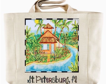 May include: Beige tote bag with a colorful illustration of a tropical scene featuring a house, palm trees, and a river. The text "St. Petersburg, FL" is printed at the bottom. The bag has two beige handles.