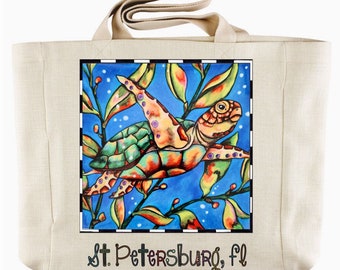 May include: A beige canvas tote bag with a colorful illustration of a sea turtle swimming in blue water with green and yellow seaweed. The text "St. Petersburg, FL" is printed on the bottom of the bag.