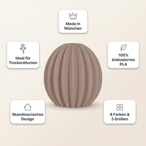 May include: A light brown, spherical vase with vertical ribbed detailing. The vase is made of 100% bio-based PLA and is part of a Scandinavian design. The vase is available in 8 colours and 3 sizes. Made in Munich.
