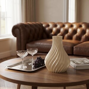Designvase Luxoria (Luxe) im Bücherregal einer Bibliothek – literarische Eleganz mit Eukalyptus-Akzent. 3D-Druck, Bambu PLA Silk+. Made in München.