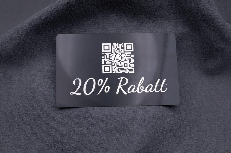 Rabattkarte aus schwarzem Aluminium mit Gravur „20% Rabatt“ und QR-Code. Robuste, langlebige Metallkarte mit edlem, modernem Look, ideal als Werbekarte, Gutscheinkarte oder exklusives Marketinginstrument. Die Karte hebt sich durch Eleganz und Stabilität von herkömmlichen Papierkarten ab.