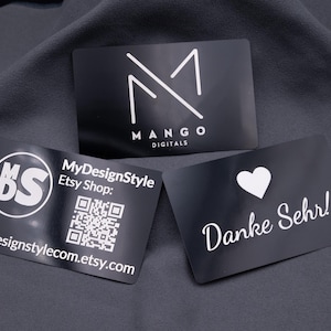 Cartão de visita em metal, alumínio, preto brilhante, personalizado com gravação a laser incluindo nome, logotipo, imagem e código QR.