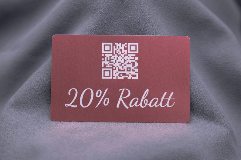 Exklusive Rabattkarte aus roségoldenem Aluminium mit Gravur „20% Rabatt“ und QR-Code. Die matte Oberfläche verleiht der Metallkarte eine edle Optik, während sie gleichzeitig stabil und langlebig ist. Ideal als stilvolle Gutscheinkarte oder Werbemittel für Unternehmen mit Anspruch an modernes Design.