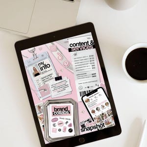 May include: A digital tablet displaying a pink and white content and services layout. The tablet shows a business card, a phone with an Instagram profile, and a collection of brand collaboration stickers. A laptop and coffee cup are also visible.