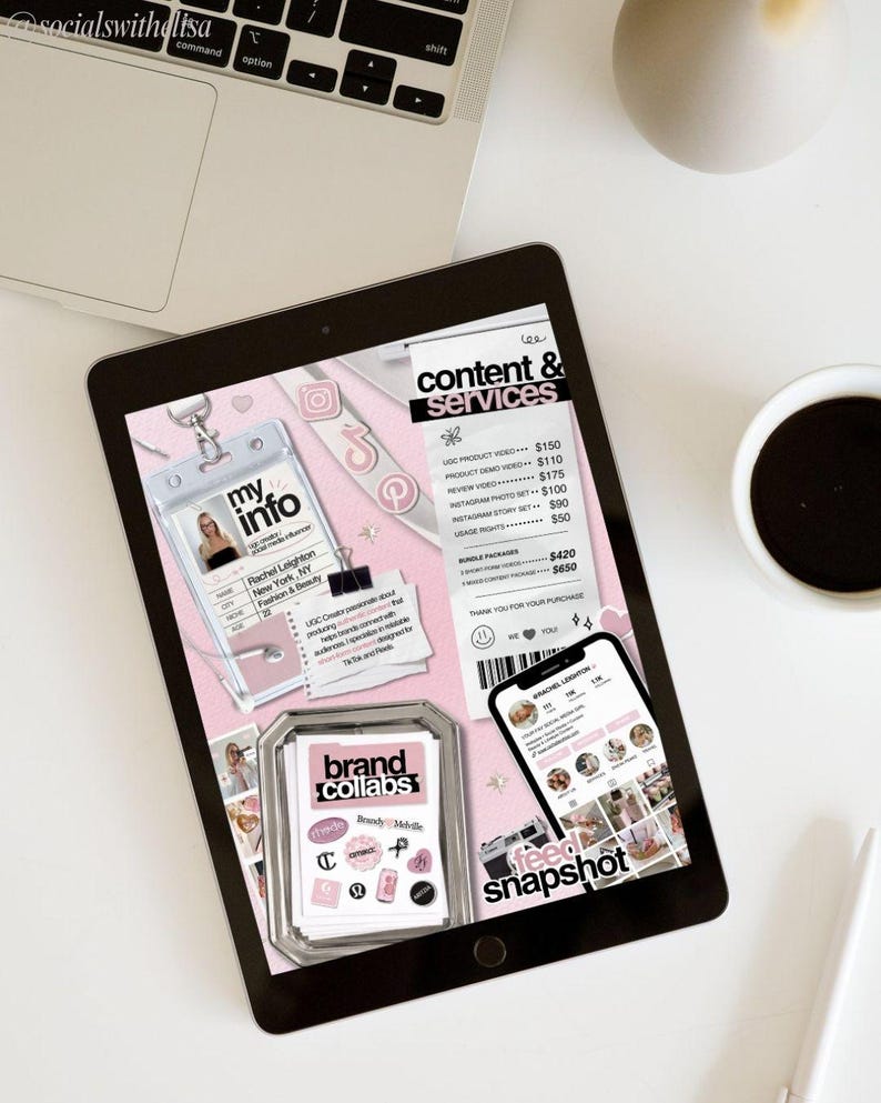May include: A digital tablet displaying a pink and white content and services layout. The tablet shows a business card, a phone with an Instagram profile, and a collection of brand collaboration stickers. A laptop and coffee cup are also visible.