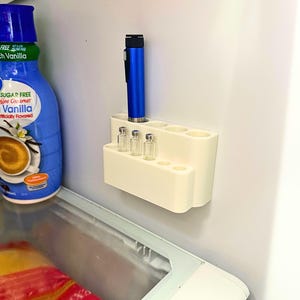 Fridge mounted GLP-1 organizer holding injection pen and small glass vials, compact peptide and insulin pen holder, space saving refrigerator storage solution for keeping medication pens upright and organized