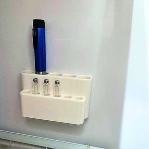 Compact refrigerator organizer for GLP-1 pens and peptide vials, wall mounted insulin pen holder with multiple slots, minimalist fridge storage solution for daily medication routines and easy access
