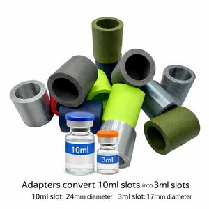 May include: A collection of coloured cylindrical adapters, including grey, green, and blue, with two glass vials labelled '10ml' and '3ml'. Text: 'Adapters convert 10ml slots into 3ml slots'. The 10ml slot is 24mm in diameter, and the 3ml slot is 17mm in diameter.