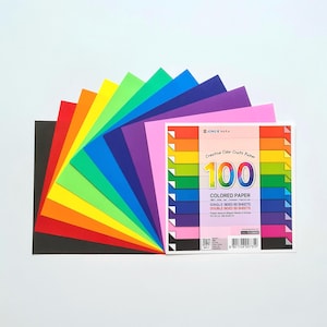 May include: A pack of 100 coloured paper sheets, single-sided and double-sided, in a rainbow of colours. The pack is labelled "Creative Color Craft Paper 100 Coloured Paper Single Sided 50 Sheets Double Sided 50 Sheets".