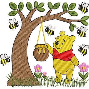May include: An embroidery design featuring a yellow bear wearing a red shirt standing under a brown tree. A brown honey pot hangs from a branch by yellow strings. Six small bees with yellow and black stripes fly around the scene, and pink flowers grow in the green grass at the base of the tree.