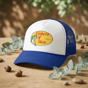May include: A blue and white trucker hat featuring a graphic on the front panel. The graphic is a yellow oval containing a green fish illustration and the red text Fishers of Men with the smaller black text Matt. 4:19 printed to the right.
