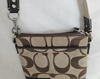 Vintage Crossbody Purse with Pockets. Displaying the Coach Name, Stamps, and Tags.