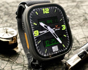 May include: A square-faced digital watch with a black face and gray band. The watch displays the date, time, and other information in green. The watch is water-resistant to 330 feet. The watch is on a map.