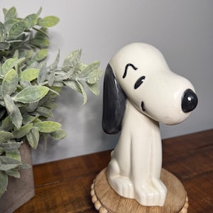 May include: A set of three ceramic nesting bowls in shades of blue, green, and white. The bowls feature a speckled design and varying sizes, perfect for food preparation or serving.