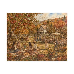 May include: A jigsaw puzzle depicting an autumn harvest festival scene with people gathered for a picnic under apple trees. The image features a white farmhouse, tables with checkered cloths, baskets of red apples, pumpkins, and a golden dog.