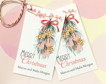 May include: Two rectangular Christmas gift tags with watercolor illustrations. Each tag features a sprig with pink berries, a red bow, and the words "Merry Christmas" in red and gray. The names "Marcus and Malia Morgan" are printed below.